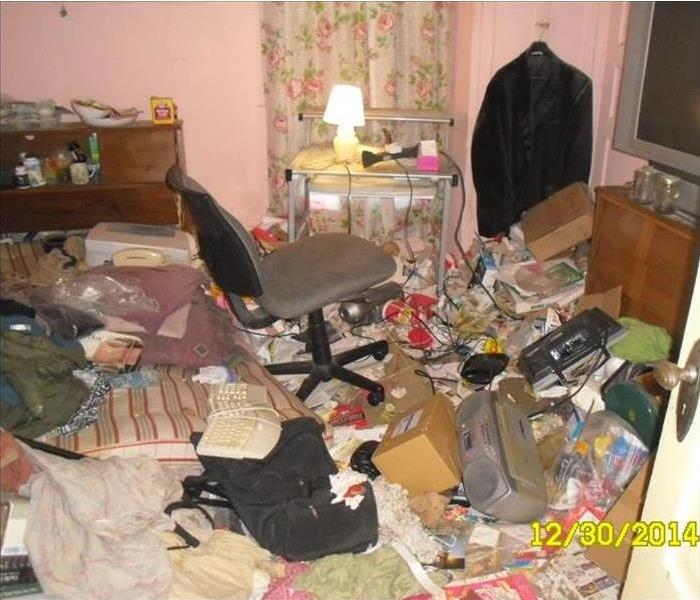 Room with massive amount of clutter and garbage